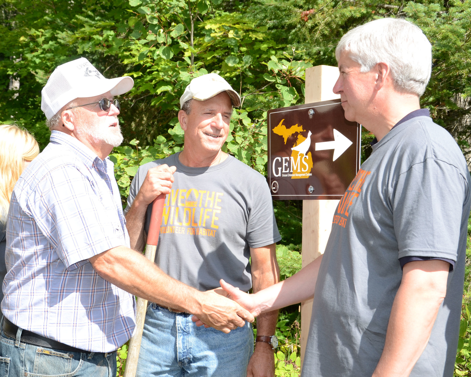 Alan Ettenhofer, left, shakes hands with Gov. Rick Snyder at a tree planting event in Marquette County in 2014.
