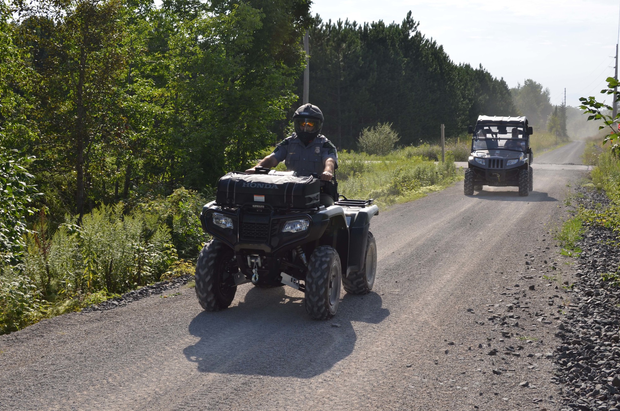 A Michigan Department of Natural Resources conservation officer, leads a group of riders down the new Hermansville to Escanaba trail in Delta County.