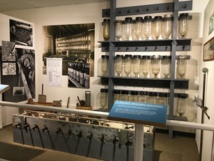 exhibit showing beakers used to raise fish from eggs