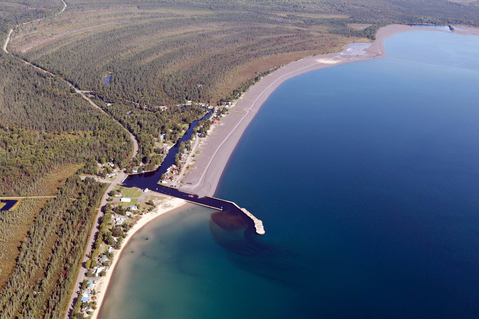 This aerial photo shows the stamp sands deposited along the coast north of the Grand Traverse Harbor and the natural beaches that lie to the south.