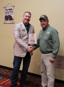 Art Pelon of NWTF Michigan chapter presents award to DNR's Clay Buchanan