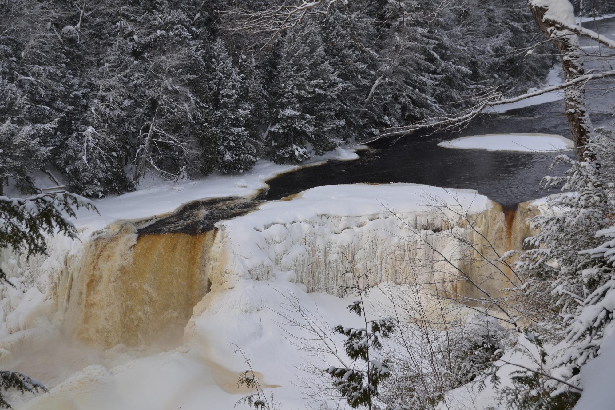 The Upper Tahquamenon Falls provide a beautiful wintry backdrop for outdoor activity.