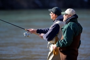instructor helps student cast during steelhead fishing clinic