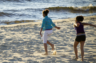 Two girls playing along the Lake Michigan beach
