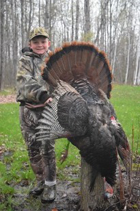 Michigan's first turkey season of the year is right around the corner. Here, a young hunter shows off his turkey.