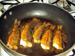 Brook trout frying in the pan at the cabin.