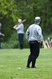 A vintage baseball pitcher stares down a batter