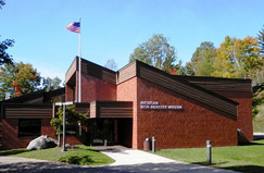 The exterior of the Michigan Iron Industry Museum in the summer