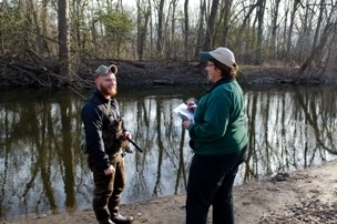 A Michigan DNR creel clerk talks with an angler about his experience fishing Michigan waters.