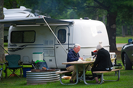 couple next to camper
