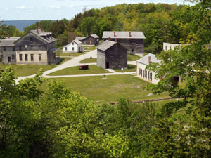 A visitor walks through the townsite at Fayette Historic State Park in Delta County.