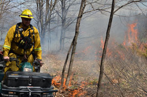 Firefighters monitor a 15-acre prescribed burn Tuesday at Fayette Historic State Park in Delta County.