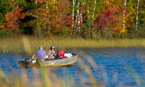 two people fishing in a boat