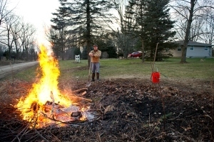 man burning debris pile