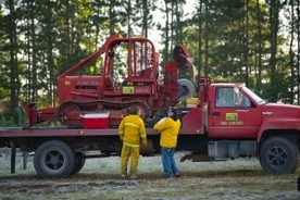 DNR fire officers load up a tractor plow to take to the scene of a wildfire