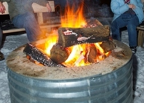small campfire in a metal ring