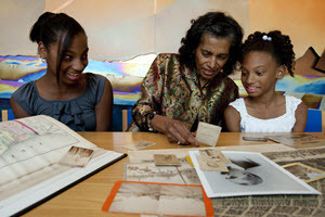 A grandmother shares family photos and records with her granddaughters