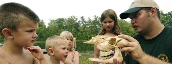 DNR staff showing kids animal skull