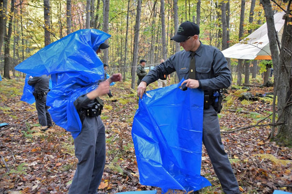 DNR conservation officer recruits learn to convert plastic bags into ponchos, which help conserve body heat in outdoor survival situations. 