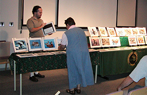 visitors looking at display of duck stamp contest entries