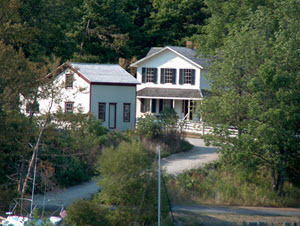 Two historic buildings at Fayette Townsite, viewed from a distance.