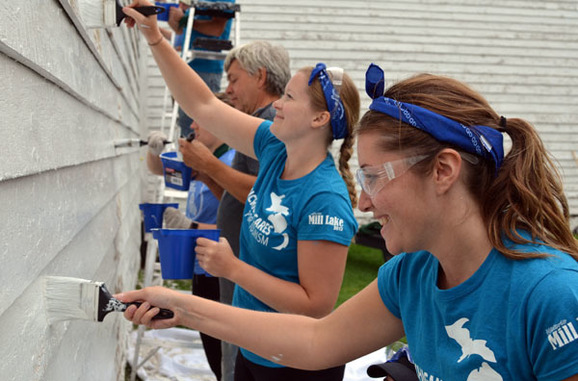 Volunteers paint a building at Fort Wilkins Historic State Park in Copper Harbor.