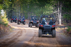 line of ORVs on trail