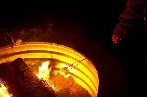 nighttime campfire in a metal ring