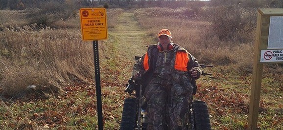 Hunter in tracked wheelchair at Sharonville State Game Area's Pierce Road Unit