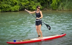 woman on a stand-up paddle board, on a Michigan river