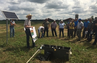 Farmers watch a presentation in the field on agricultural water solutions