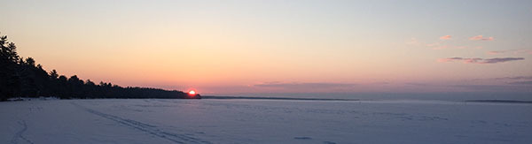sunrise over frozen lake