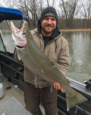 Chad Kamm of Metamora, Michigan, holds the rainbow trout he caught on the Manistee RIver and submitted for Master Angler recognition.