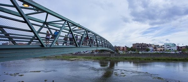 People cross a bridge over the River Raisin - City of Monroe