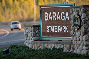 The sign at the entrance to Baraga State Park is shown.