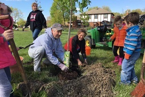 Volunteers of all ages help out with tree planting at a 2018 Arbor Day event in Riverview, Michigan