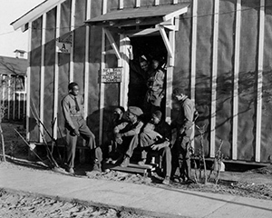 Enrollees at Civilian Conservation Corps Camp Bitely in Mason County socialize outside their barracks.