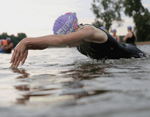 swimmer diving under water in lake