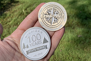 two geocoins on hand