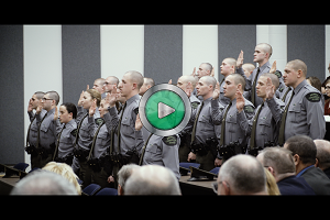 thumbnail image from CO academy recruiting video, showing officers taking oath - play button