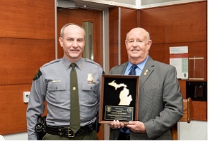 Michigan DNR Law Chief Gary Hagler and Dennis McMahan, holding his Hunter Safety Instructor of the Year award