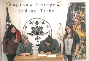signing the MOU for co-management of Sanilac Petroglyphs Historic State Park