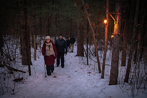 snowshoers on lantern-lit hike