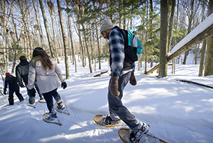 A group snowshoeing in Muskegon State Park