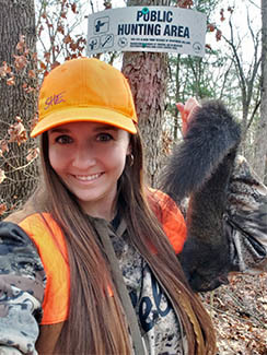 Hunter Heather Iverson is pictured with a squirrel after a successful hunt.
