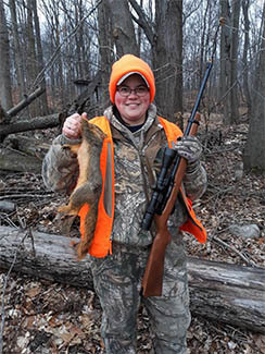 Kelsey Fisher is pictured with a squirrel after a successful hunt.