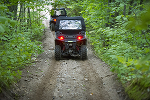 Two ORVs riding on trail
