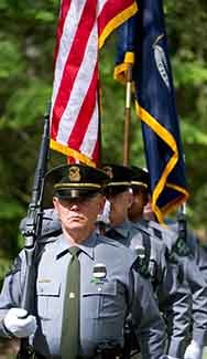 A line of conservation officers in uniform is shown.