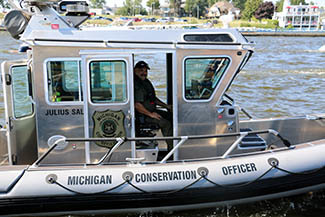 Conservation officer Ivan Perez is shown in a fishing safe boat.
