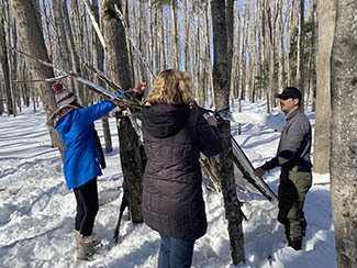 Shelter building is being taught to two women at the February BOW event in Marquette County.